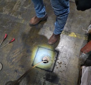 Close-up of complex stainless steel pipes in an industrial setting, showcasing modern engineering.