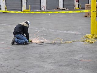 Large indoor terminal with people reflected on glossy floors, emphasizes modern architecture.