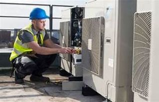 Two technicians repair a rooftop HVAC unit outside a Walmart store.